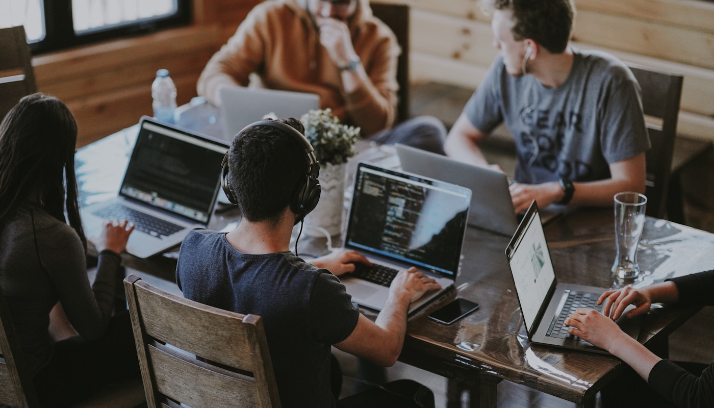 Team collaborating over documents at a desk
